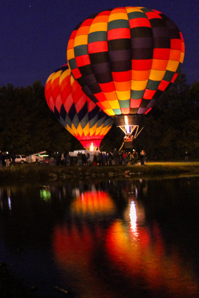 Two hot air balloons taking off into the air