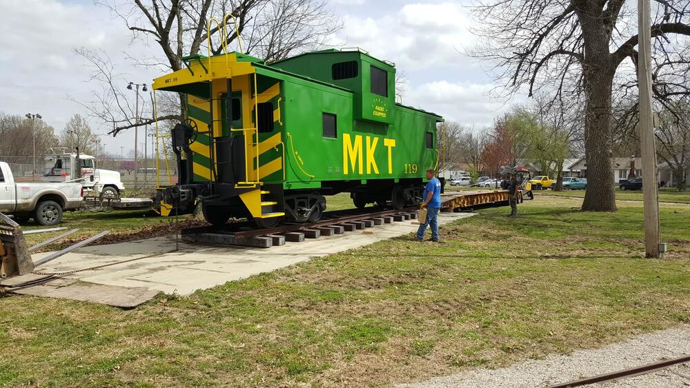 Workers looking at the green caboose