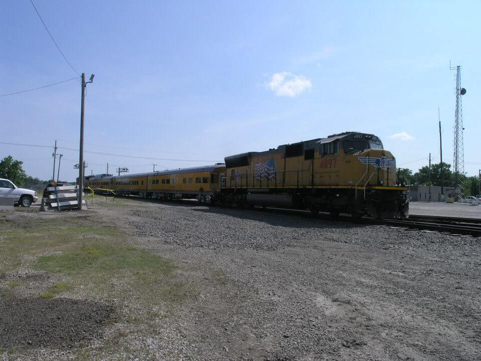 Side view of the yellow Union Pacific Columbine train showcasing the many carts attached
