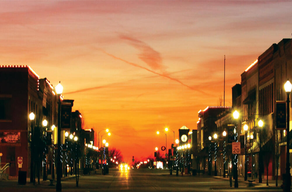 A sunset view down a street in Parsons